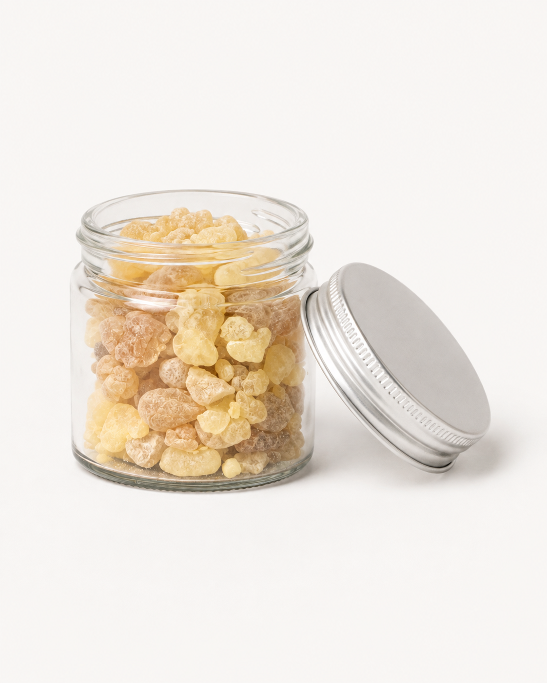 Open jar of Maydi resin with the silver lid resting beside it